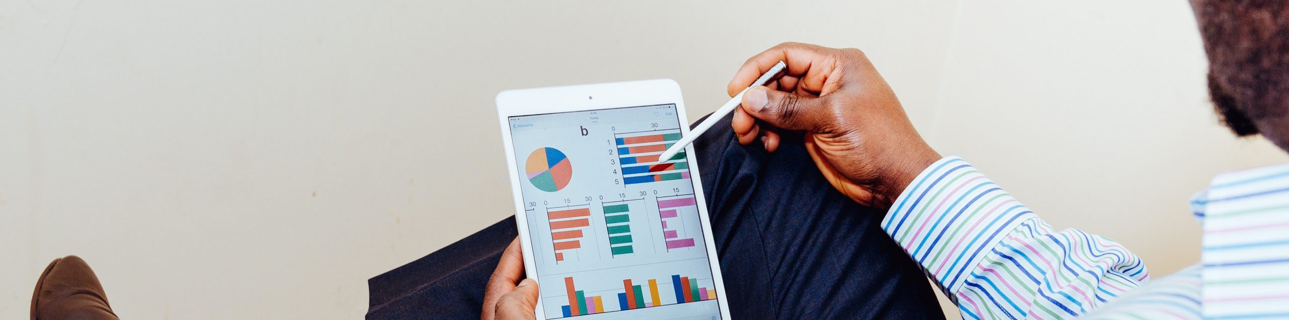 finance-header-man-on-tablet-with-charts tax effective finance